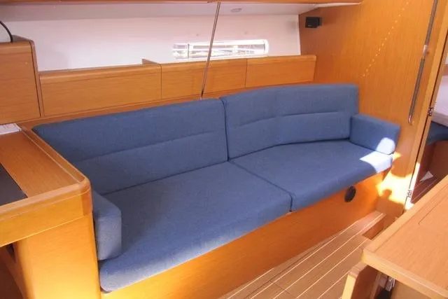 Slide: The Image of Interior of 2011 Jeanneau Sun Odyssey 42 DS with blue sofa and wooden finish. - 1