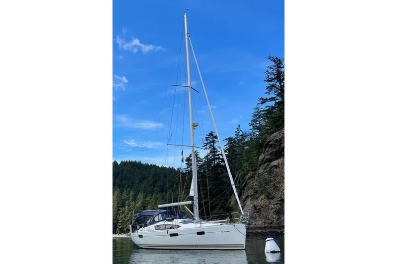 Slide: The Image of 2011 Jeanneau Sun Odyssey 42 DS sailboat anchored near forested shoreline. - 10