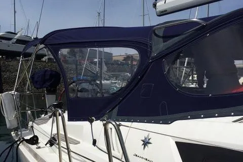 Slide: The Image of 2011 Jeanneau Sun Odyssey 42 DS sailboat with blue canopy docked at marina. - 6
