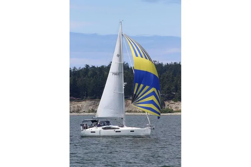 Slide: The Image of 2011 Jeanneau Sun Odyssey 42 DS sailing with vibrant blue and yellow spinnaker. - 7