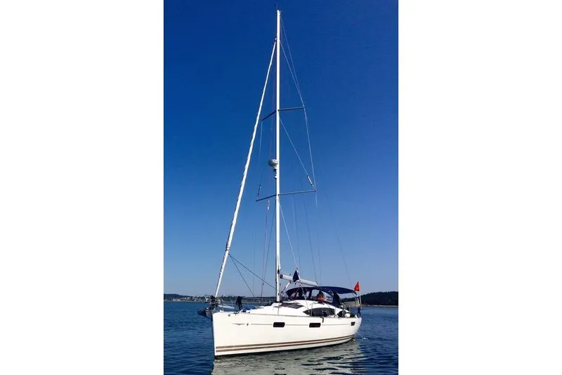 Slide: The Image of 2011 Jeanneau Sun Odyssey 42 DS sailboat on calm water under clear blue sky. - 9