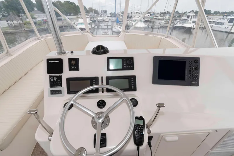Slide: The Image of Cockpit view of 2004 Ocean Yachts 52 SUPER SPORT with navigation equipment and steering wheel. - 12