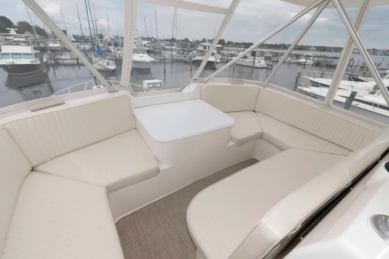 Slide: The Image of Luxurious seating area on a 2004 Ocean Yachts 52 SUPER SPORT at a marina. - 13