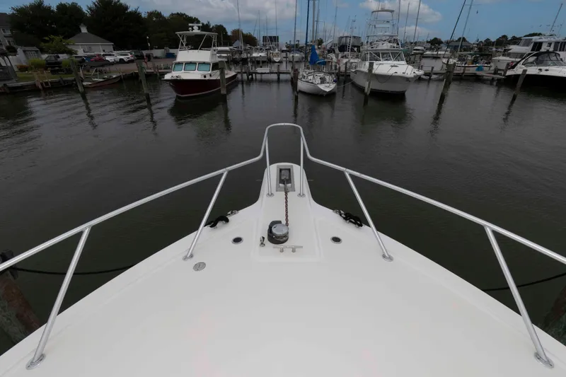 Slide: The Image of Bow view of 2004 Ocean Yachts 52 SUPER SPORT docked at a marina. - 15