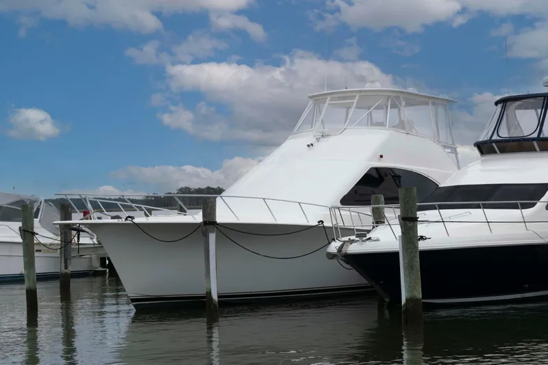 Slide: The Image of 2004 Ocean Yachts 52 SUPER SPORT docked under a blue sky. - 2