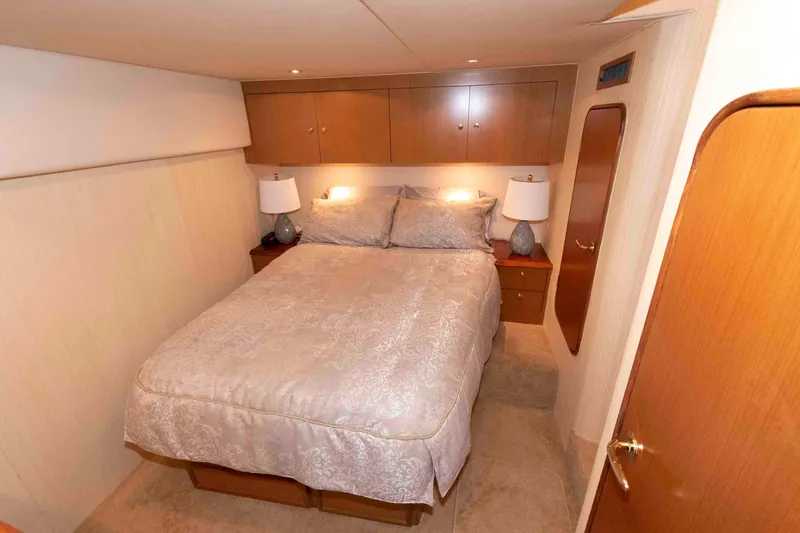 Slide: The Image of Luxurious bedroom interior of 2004 Ocean Yachts 52 Super Sport with elegant bedding and wooden cabinetry. - 28