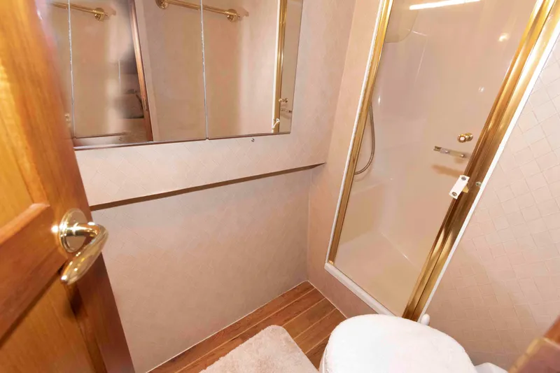 Slide: The Image of Luxurious bathroom in 2004 Ocean Yachts 52 SUPER SPORT with shower and wooden accents. - 29