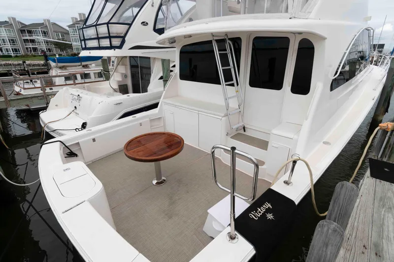 Slide: The Image of 2004 Ocean Yachts 52 SUPER SPORT docked, featuring spacious deck and elegant design. - 3