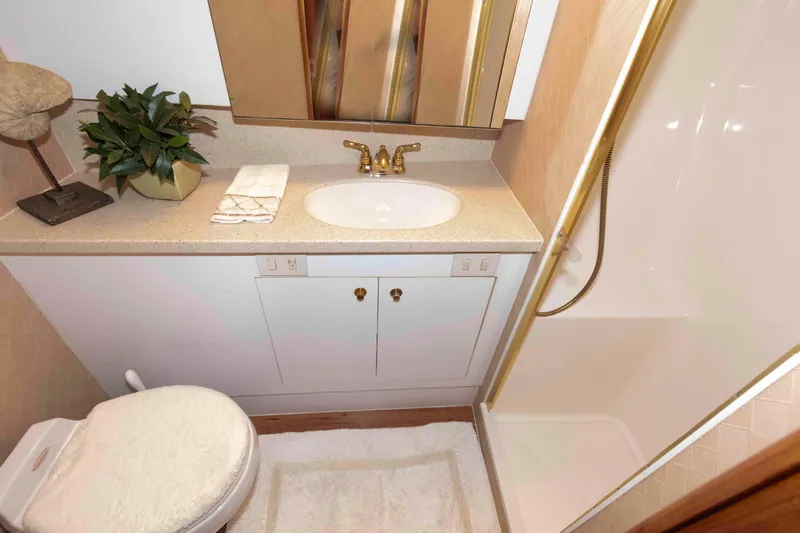 Slide: The Image of Luxurious bathroom in 2004 Ocean Yachts 52 SUPER SPORT with gold fixtures and shower. - 35