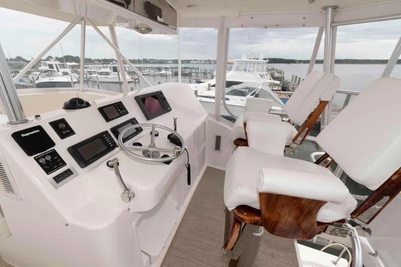 Slide: The Image of Cockpit of 2004 Ocean Yachts 52 SUPER SPORT with modern navigation equipment and plush seating. - 8