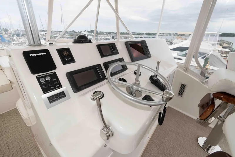 Slide: The Image of Cockpit of 2004 Ocean Yachts 52 Super Sport with navigation equipment and steering wheel. - 11