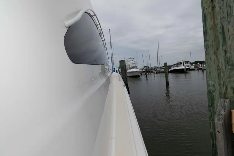 Slide: The Image of 2004 Ocean Yachts 52 SUPER SPORT docked in a marina, side view. - 17