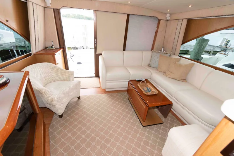 Slide: The Image of Luxurious interior of 2004 Ocean Yachts 52 SUPER SPORT with white seating and wooden accents. - 23