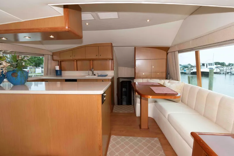 Slide: The Image of Luxurious interior of 2004 Ocean Yachts 52 SUPER SPORT with elegant dining and kitchen area. - 24
