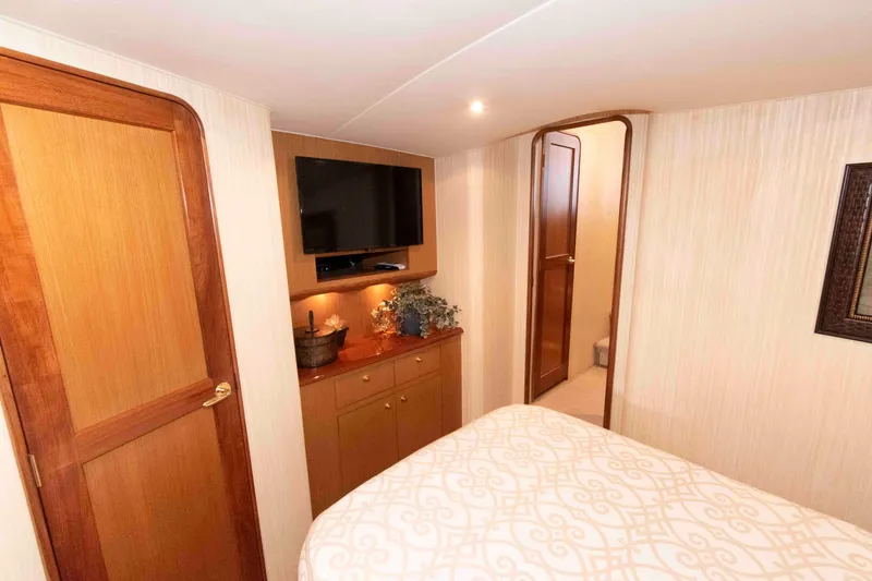 Slide: The Image of Luxurious cabin interior of 2004 Ocean Yachts 52 SUPER SPORT with TV and elegant decor. - 32