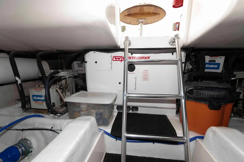 Slide: The Image of Engine room of 2004 Ocean Yachts 52 SUPER SPORT with ladder and equipment. - 42