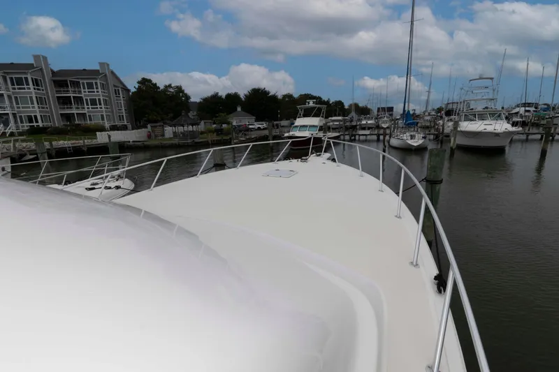 Slide: The Image of 2004 Ocean Yachts 52 SUPER SPORT docked at marina under cloudy sky. - 7
