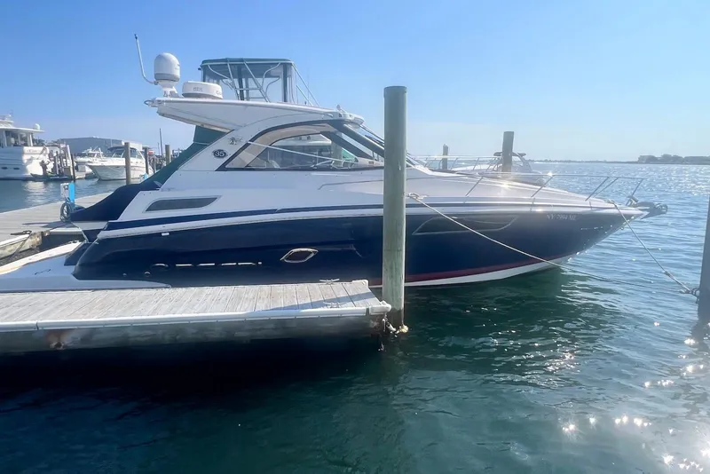 The Image of 2017 Regal 35 Sport Coupe docked at marina under clear blue sky. - 0