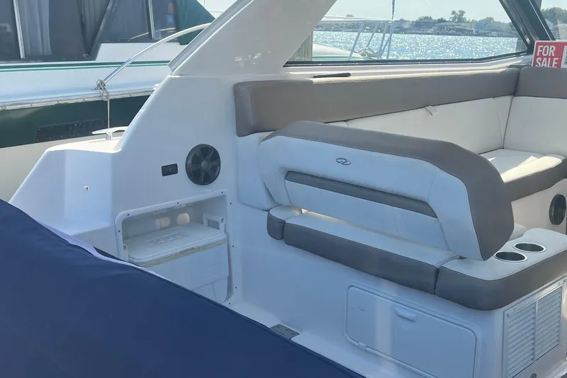 Slide: The Image of 2017 Regal 35 Sport Coupe interior with seating and storage, for sale sign visible. - 11