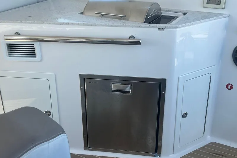 Slide: The Image of 2017 Regal 35 Sport Coupe boat kitchen area with grill and storage compartments. - 12