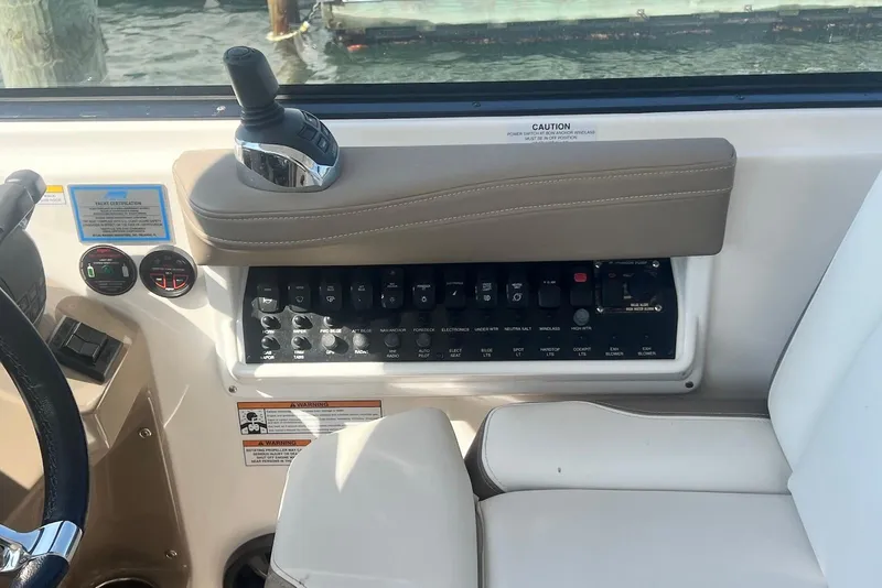 Slide: The Image of Control panel of a 2017 Regal 35 Sport Coupe boat with joystick and switches. - 13