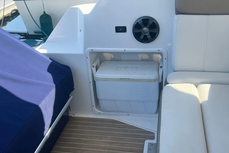 Slide: The Image of 2017 Regal 35 Sport Coupe interior with cooler storage and seating area. - 14