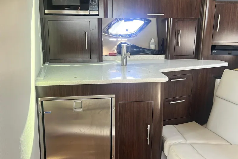 Slide: The Image of 2017 Regal 35 Sport Coupe interior kitchen with modern appliances and sleek cabinetry. - 16