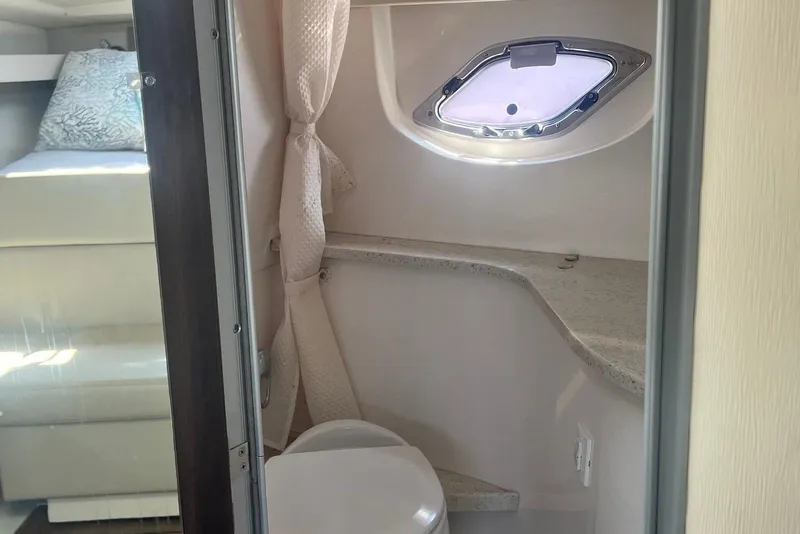 Slide: The Image of Interior of 2017 Regal 35 Sport Coupe bathroom with window and countertop. - 17