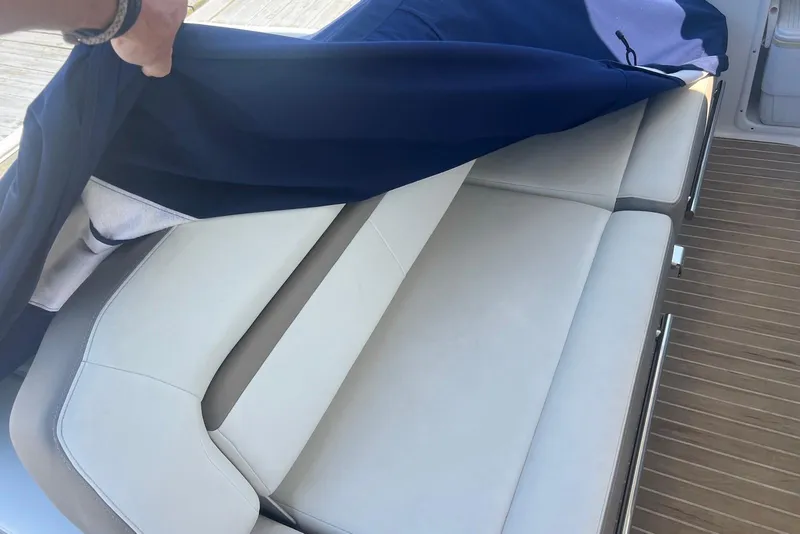 Slide: The Image of 2017 Regal 35 Sport Coupe interior with covered white seating and wooden flooring. - 3