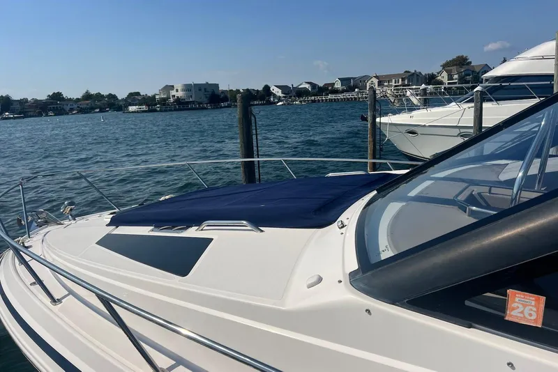 Slide: The Image of 2017 Regal 35 Sport Coupe docked by waterfront homes on a sunny day. - 4
