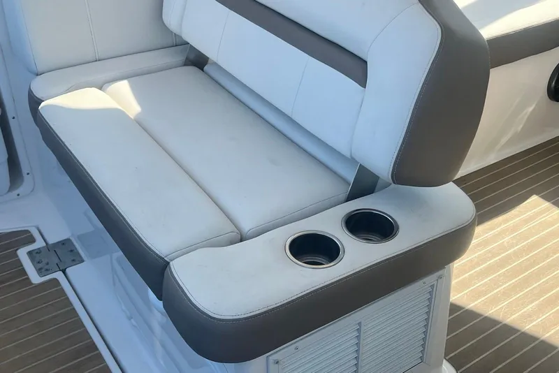 Slide: The Image of 2017 Regal 35 Sport Coupe seating with cup holders on a wooden deck. - 7