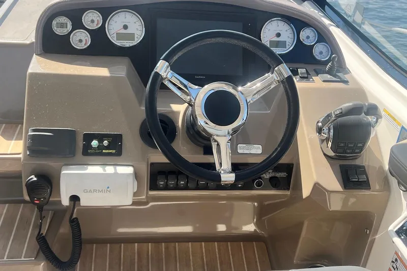 Slide: The Image of 2017 Regal 35 Sport Coupe helm with steering wheel, gauges, and Garmin navigation system. - 8