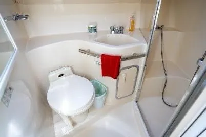 Slide: The Image of 1997 Sea Ray 400 Express Cruiser bathroom with toilet, sink, and shower. - 22