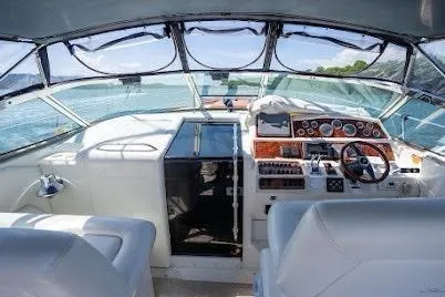 Slide: The Image of 1997 Sea Ray 400 Express Cruiser cockpit with steering wheel, dashboard, and seating. - 26