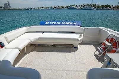 Slide: The Image of 1997 Sea Ray 400 Express Cruiser with spacious deck and seating, overlooking calm waters. - 27