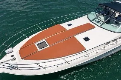 Slide: The Image of 1997 Sea Ray 400 Express Cruiser on water, featuring spacious deck and sleek design. - 5