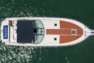 Slide: The Image of 1997 Sea Ray 400 Express Cruiser on water, aerial view, sleek design, white and brown deck. - 7