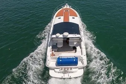 Slide: The Image of 1997 Sea Ray 400 Express Cruiser navigating on open water, aerial view. - 8