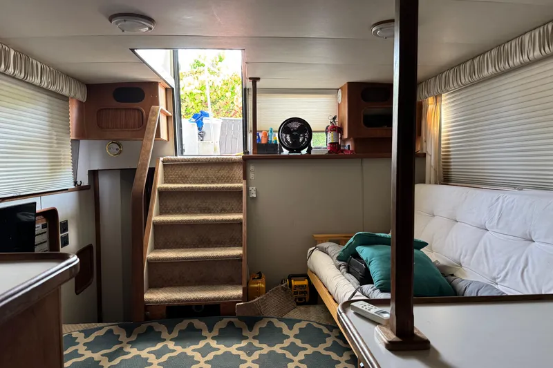 Slide: The Image of Interior of 1990 Carver 3608 Aft Cabin with stairs, sofa, and nautical decor. - 14