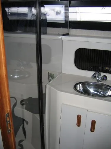 Slide: The Image of 1990 Carver 3608 Aft Cabin Motor Yacht bathroom with sink and mirror. - 18