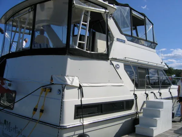 Slide: The Image of 1990 Carver 3608 Aft Cabin Motor Yacht docked, featuring spacious aft deck and cabin. - 3