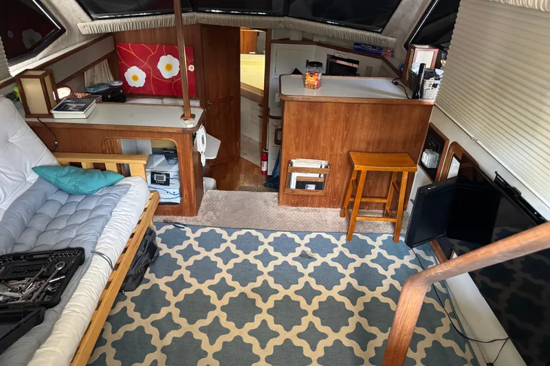 Slide: The Image of Interior of 1990 Carver 3608 Aft Cabin with cozy seating and nautical decor. - 9