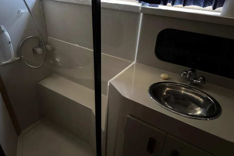 Slide: The Image of 1990 Carver 3608 Aft Cabin bathroom with shower, sink, and soap. - 17