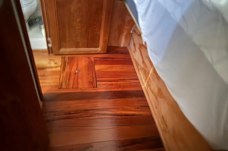 Slide: The Image of 1990 Carver 3608 Aft Cabin interior with polished wooden flooring and cabinetry. - 19