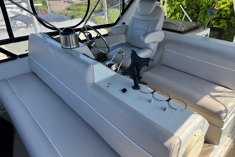 Slide: The Image of 1990 Carver 3608 Aft Cabin interior with steering wheel and seating area. - 20