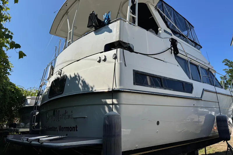 Slide: The Image of 1990 Carver 3608 Aft Cabin yacht docked in Vermont under clear blue sky. - 4