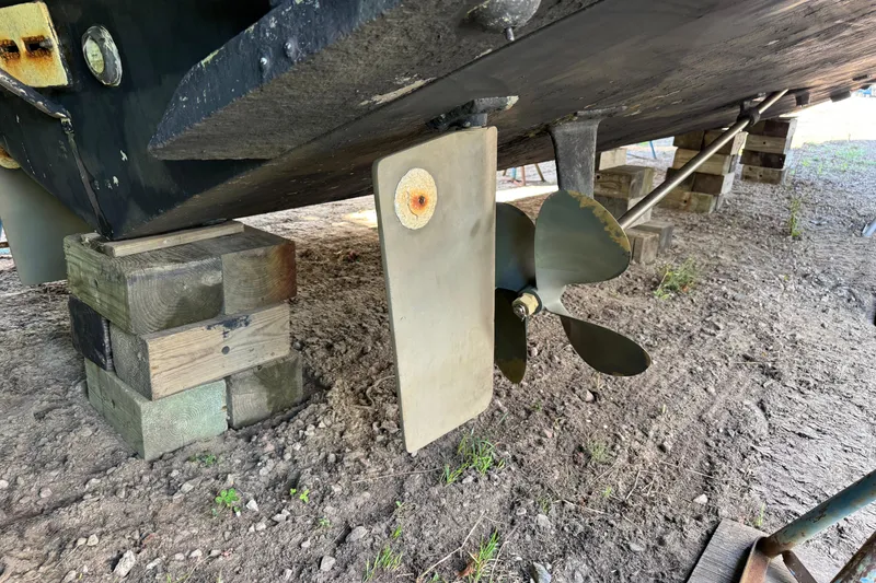 Slide: The Image of Underneath view of a 1990 Carver 3608 Aft Cabin boat, showing propeller and rudder. - 6