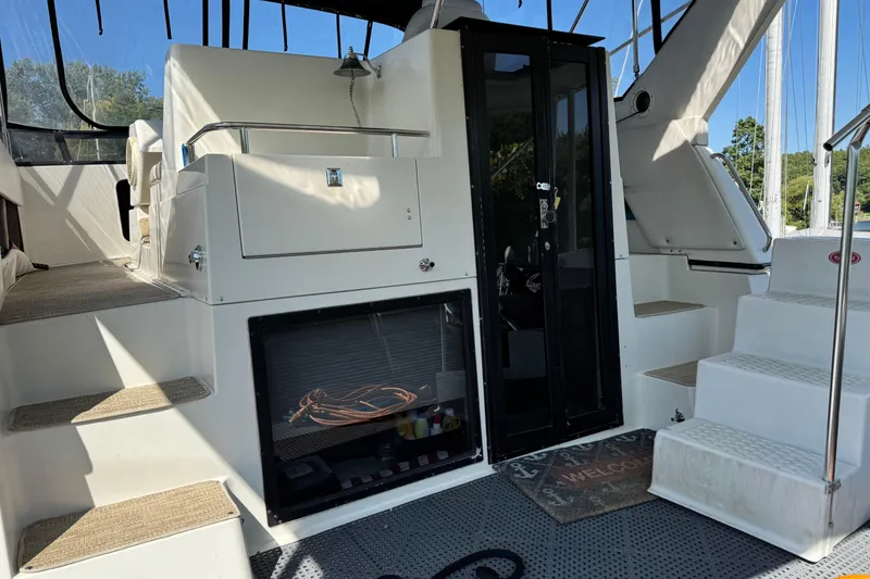 Slide: The Image of 1990 Carver 3608 Aft Cabin interior with steps, glass door, and welcome mat. - 7