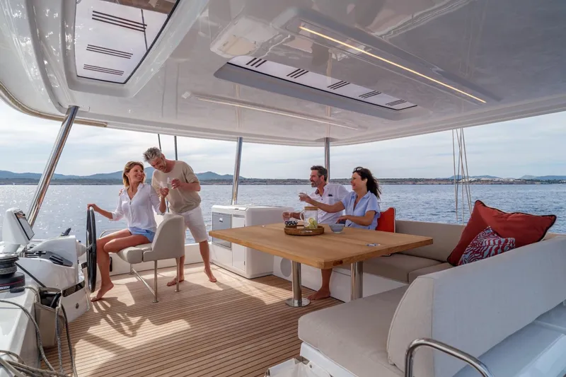 Slide: The Image of People enjoying leisure time on a 2026 Lagoon 55 yacht, with ocean views. - 12