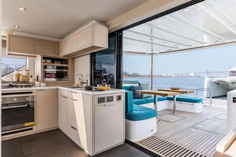 Slide: The Image of Modern kitchen and dining area on 2026 Lagoon 55 yacht with scenic water view. - 18
